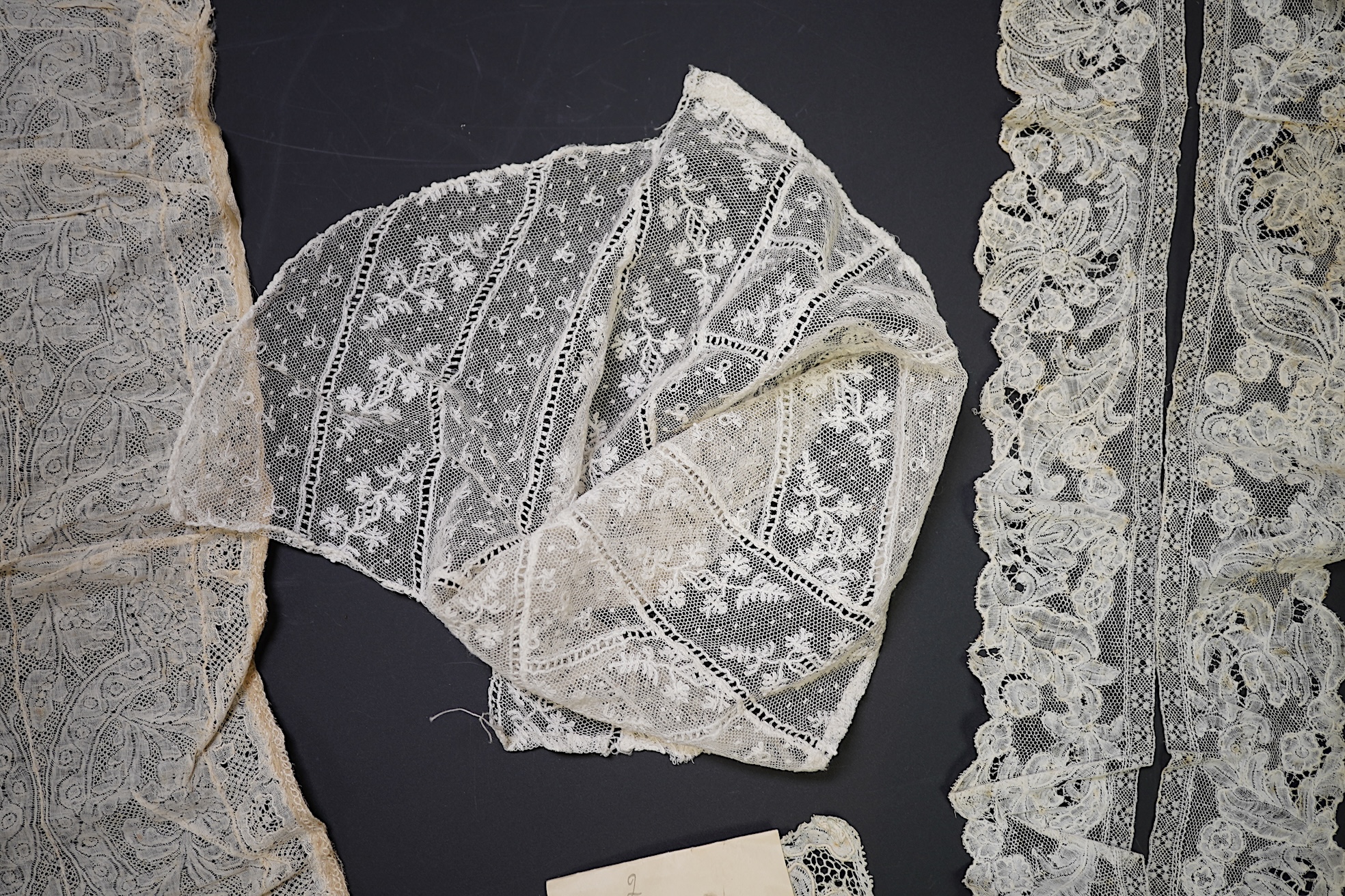 Various lengths of 18th and 19th century lace trimming and two needle run bonnets. Including a collar made from two rows of 18th century Valenciennes lace, a length Valenciennes lace, a shorter length of Pointe de Anglet